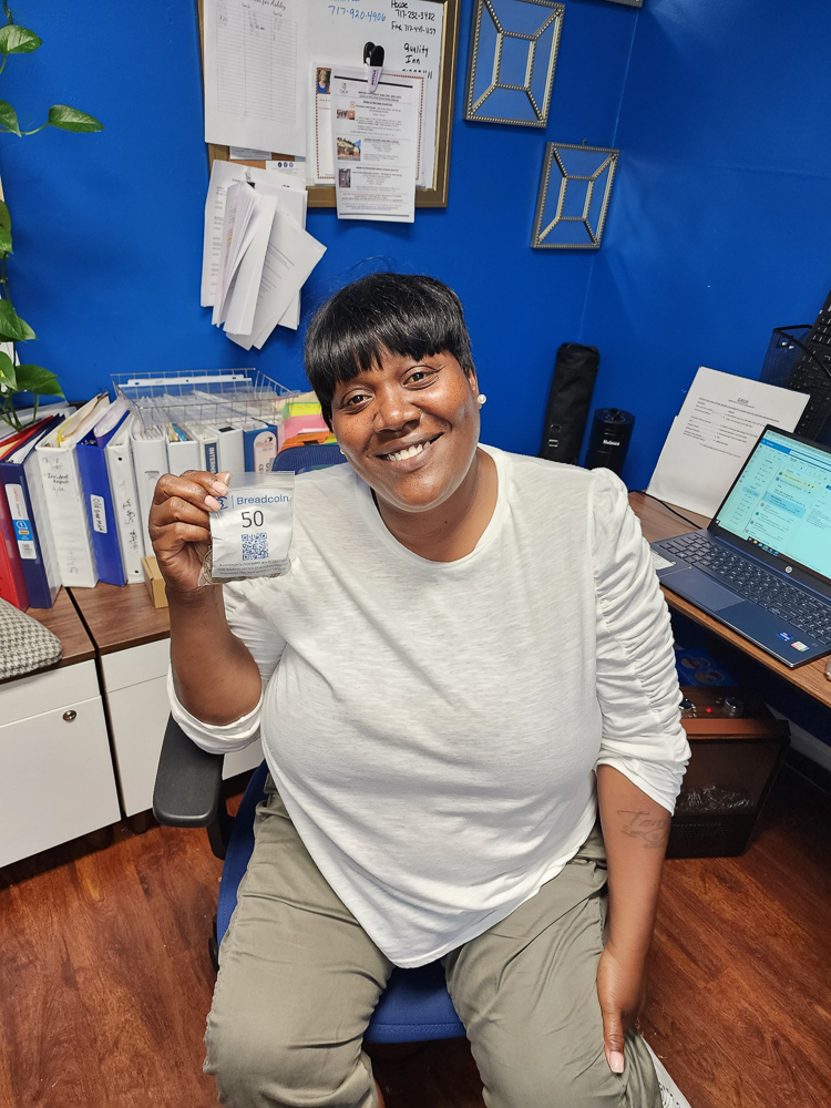 Woman in office holding breadcoin currency